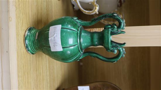 A Chinese green glazed pottery twin handled vase, in Tang style, 20.5cm.